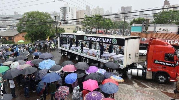 Coffins are taken to the club's stadium in a lorry ahead of last year's memorial service