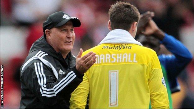 Russell Slade pats Cardiff City goalkeeper David Marshall on the back