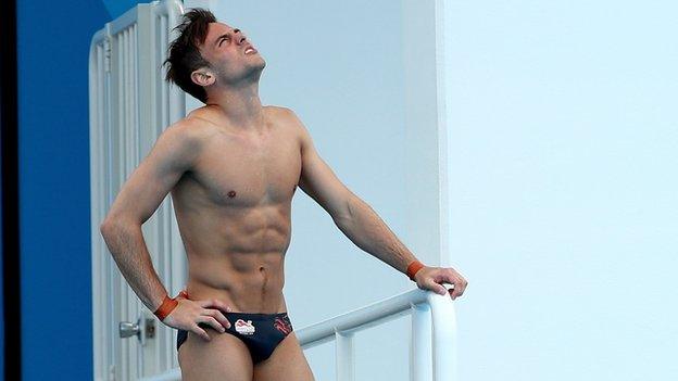 Tom Daley feels his hip during training on the Gold Coast