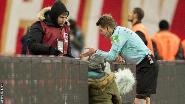 Referee Patrick Ittrich checks the video assistant referee (VAR) during the Bundesliga match between RB Leipzig and Mainz 05