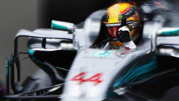 Lewis Hamilton celebrates being quickest in first practice