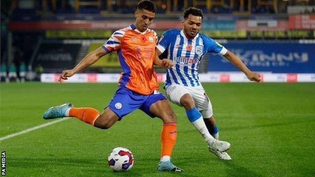 Swansea City's Kyle Naughton and Huddersfield Town's Duane Holmes (right) challenge for the ball