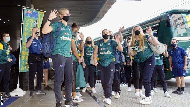 Australia's softball team waving outside their hotel