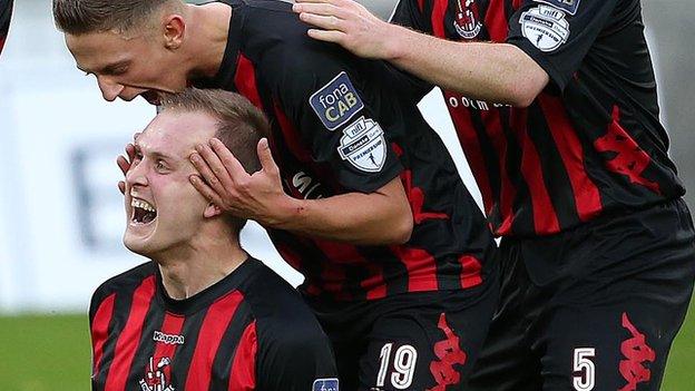 Jordan Owens is congratulated after scoring the Crusaders winner at Windsor Park