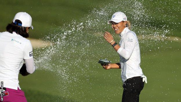 Danielle Kang is sprayed with champagne