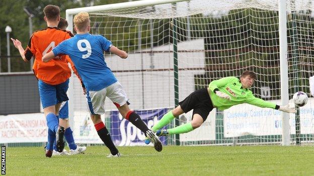 Zac Rudden scores one of his three goals against County Fermanagh at Ballymena Showgrounds