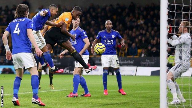 Wily Boly heads past Kasper Schmeichel