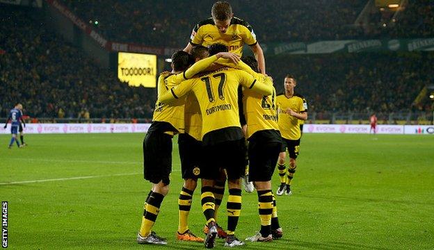 Pierre-Emerick Aubameyang is mobbed by his team-mates after scoring for Borussia Dortmund against Ingolstadt