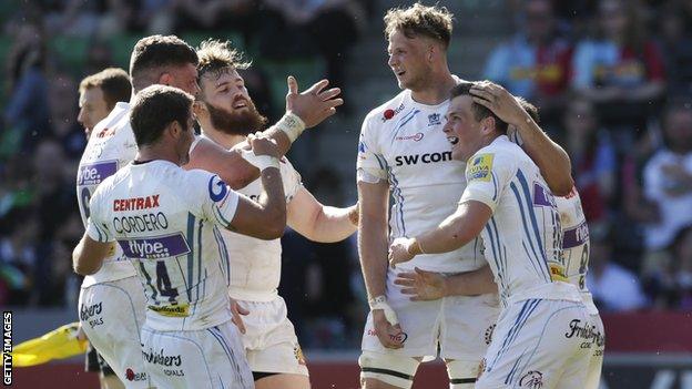 Exeter players celebrate a try by Joe Simmonds