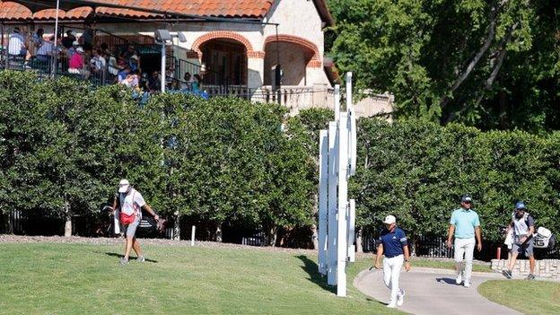 Fans watch the action at Colonial Country Club from a makeshift grandstand