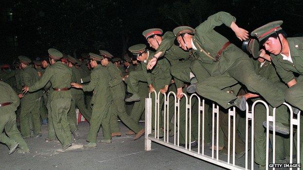 People Liberation Army (PLA) soldiers leap over a barrier on Tiananmen Square in central Beijing 4 June 1989 during heavy clashes with people and dissident students. On the night of 3 and 4 June 1989, Tiananmen Square sheltered the last pro-democracy supporters