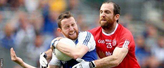 Tyrone sub Justin McMahon challenges Monaghan's Owen Duffy