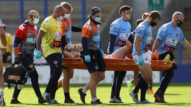 Harry Newman is carried off the field on a stretcher