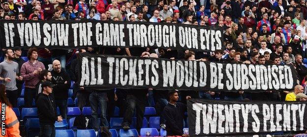 Crystal Palace supporters hold banners to protest against ticket price hike during the Barclays Premier League match between Crystal Palace and West Bromwich Albion at Selhurst Park on October 3, 2015