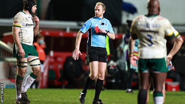 Wayne Barnes shows London Irish centre Terrence Hepetema a red card against Leicester