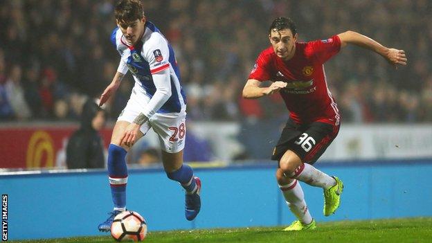 Connor Mahoney in action against Manchester United's Matteo Darmian