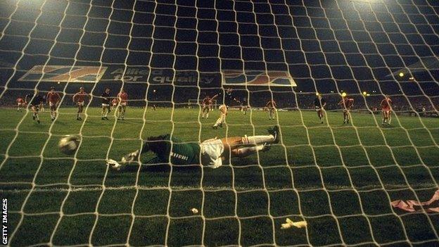 Davie Cooper of Scotland beats Welsh Goalkeeper Neville Southall