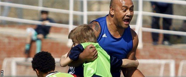 Jonah Lomu in a training session with young fans