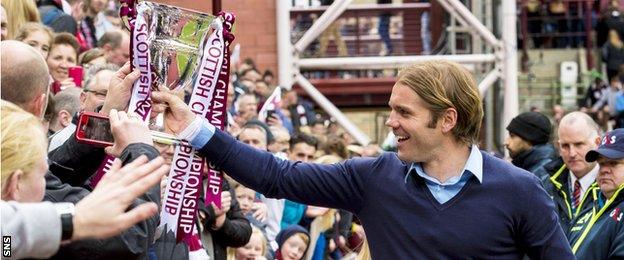 Robbie Neilson parades the Scottish Championship trophy before Hearts fans