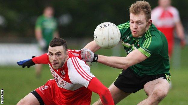 Derry's Daniel McKinless battles with QUB's Gerard McGovern in last year's McKenna Cup match at Greenlough