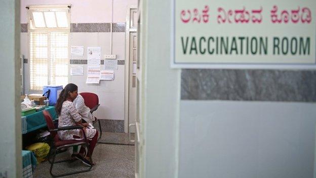 An Indian woman receives a shot of COVID-19 vaccine during the vaccination drive at Dasappa government hospital in Bangalore, India, 25 February 2021.