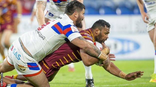 Wakefield's David Fifita is unable to prevent Huddersfield's Ukuma Ta'ai scoring a try