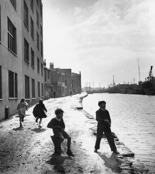 April 1950: Skimming stones along the Glamorganshire canal which was built to transport coal by the tonne from the south Wales valleys 30-or-so miles from the city