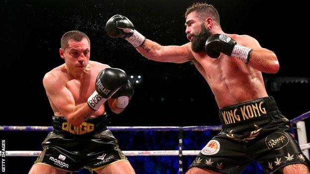 Jono Carroll punches Scott Quigg during the Super-Featherweight fight