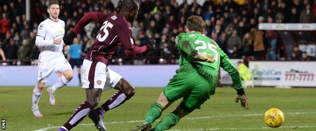 Hearts' Abiola Dauda rounds goalkeeper Owain Fon Williams