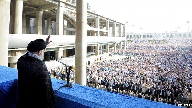 Iran"s Supreme Leader Ayatollah Ali Khamenei waves to Iranian Muslims during morning prayers for the Eid al-Fitr holiday, marking the end of the holy month of Ramadan, at the Imam Khomeini grand mosque in central Tehran