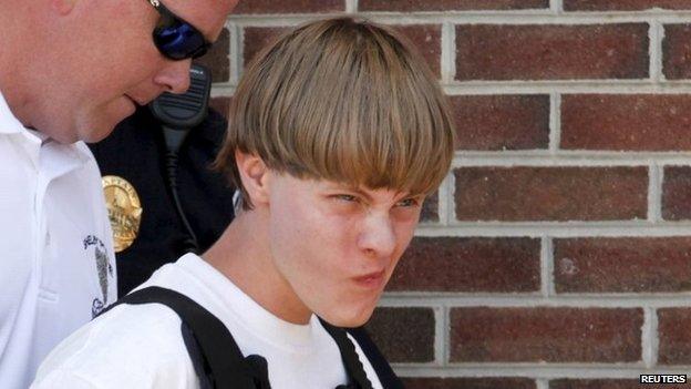 Police lead suspected shooter Dylann Roof, 21, into the courthouse in Shelby, North Carolina, 18 June 2015.