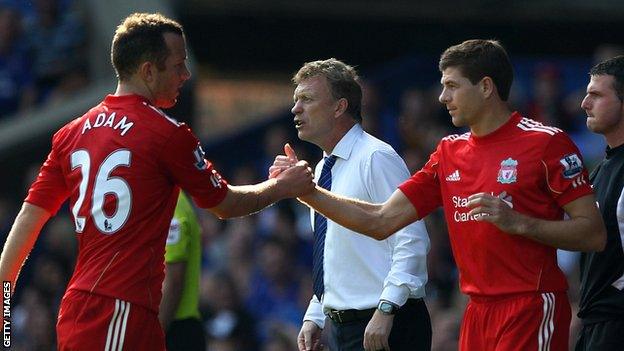 Charlie Adam shakes hands with Steven Gerrard as he is substituted playing for Liverpool