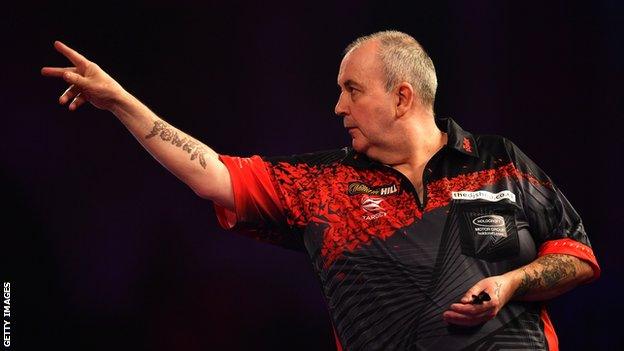 Phil Taylor throws a dart