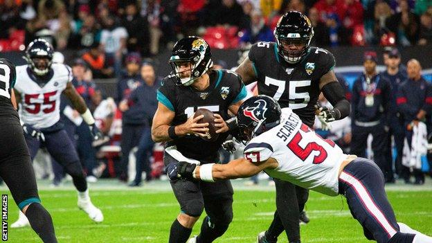 Jacksonville Jaguars quarterback Gardner Minshew is sacked against the Houston Texans at Wembley Stadium