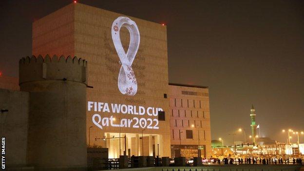 The 2022 World Cup logo projected onto a building in Qatar