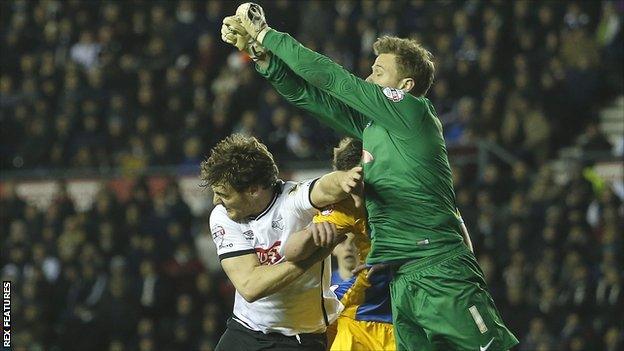 Preston keeper Anders Lindegaard punches clear