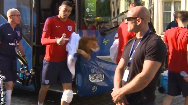 Chris Smalling leaves the England team bus after training on Tuesday - with his knee strapped and iced