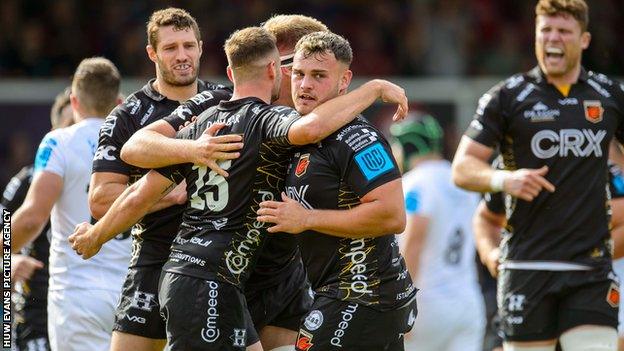 Dragons celebrate the opening try against Ospreys