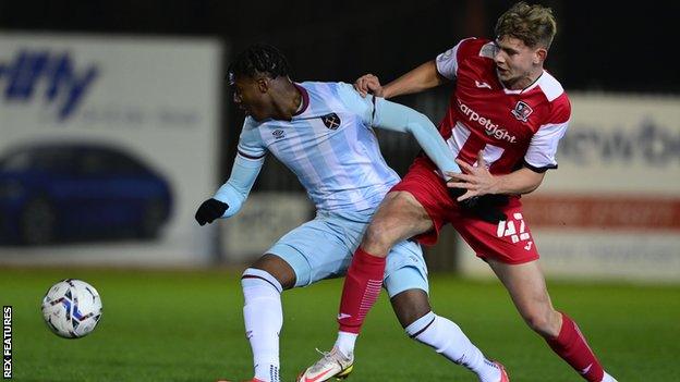 Alfie Pond of Exeter City challenges Thierry Nevers of West Ham United during the Premier League Cup Match between Exeter City U23 and West Ham U23