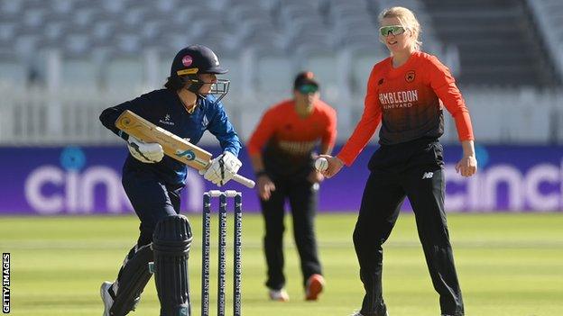 Bowler Charlie Dean jokingly threatens to run out batter Linsey Smith at the non-striker's end