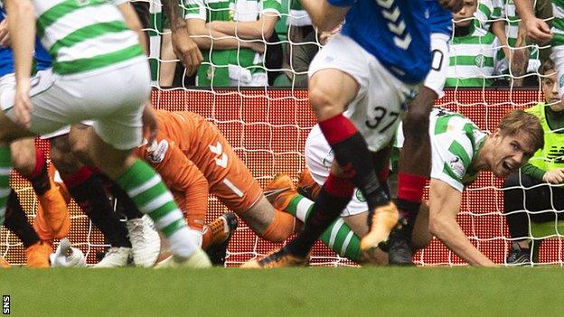 Rangers' Allan McGregor kicks out at Celtic's Kristoffer Ajer