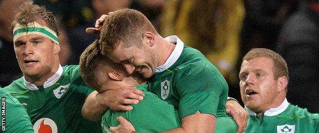 Paddy Jackson is embraced by Ian Madigan after Ireland's win in Cape Town