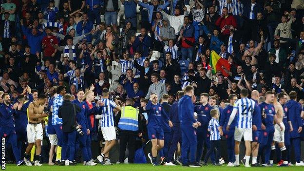 Fans spilled onto the pitch at the John Smith's Stadium following full-time in Huddersfield's Championship play-off semi-final win over Luton