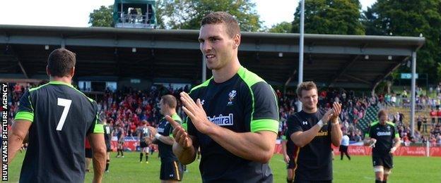 Wales' north Walian wing George North applauds the fans at Parc Eirias