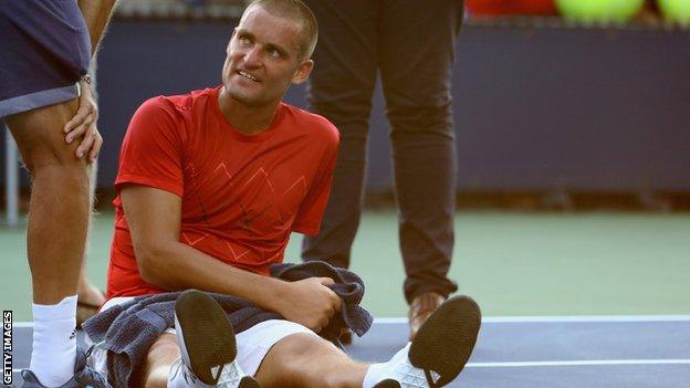 Mikhail Youzhny is treated on court before retiring in his US Open first-round match