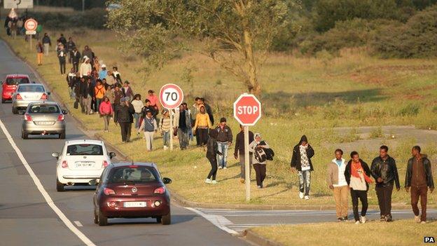 Migrants walking towards the Eurotunnel site at Coquelles in Calais