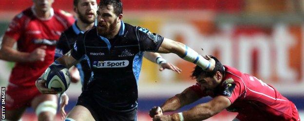 Glasgow's Sean Lamont holds off a challenge against Scarlets