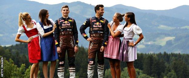 Red Bull's Daniel Ricciardo and Max Verstappen pose with some Formula Unas girls in their lederhosen themed race suits