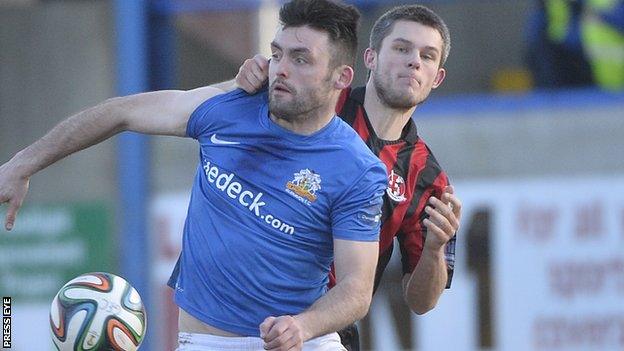 Glenavon forward Eoin Bradley is challenged by Craig McClean of Crusaders