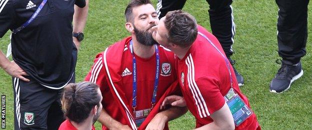 Joe Ledley and Wayne Hennessey kiss